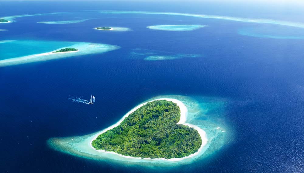 Aerial view of heart-shaped island in the Maldives.