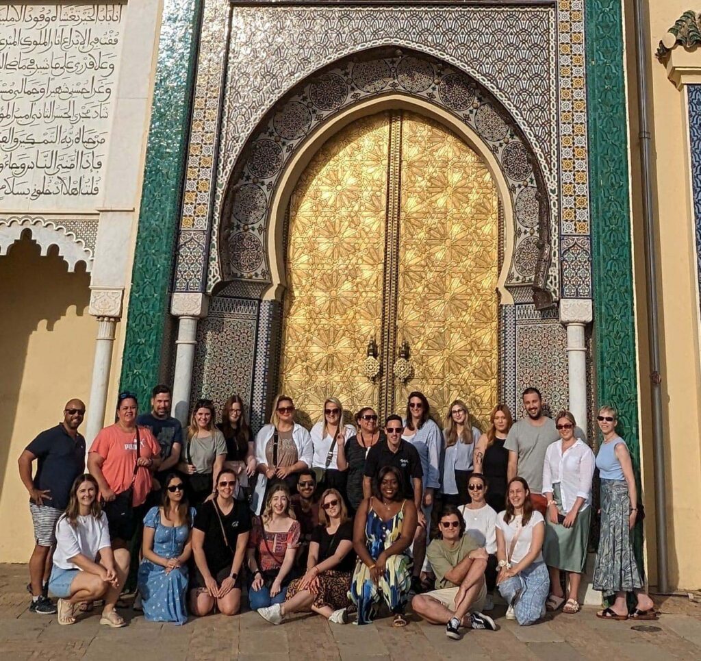 Group of travellers in front of door in Morocco