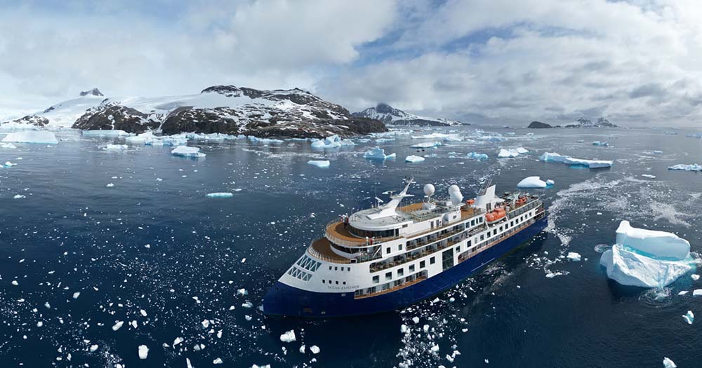 Aerial shot of Quark Expeditions' polar expedition ship Ocean Explorer surrounded by ice and water.
