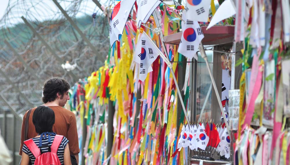Prayer ribbons tied to the fence left by visitors wishing peace and unification for North and South Korea Yeongsik Im shutterstock 654380077