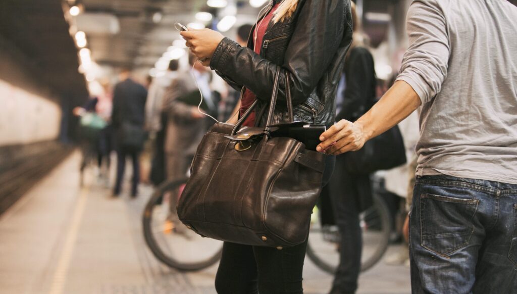 Europe travel tips: How Aussies can avoid insurance issues abroad, including this common mistake 1 A man's hand reaching into a woman's handbag while she faces a train track at a train station. Travel insurance issues