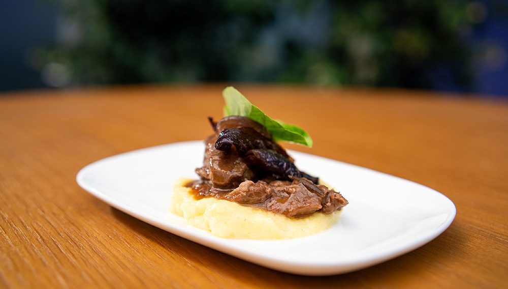 Air NZ Slow cooked wild Fiordland Venison with pancetta parmesan polenta and balsamic roasted red onions