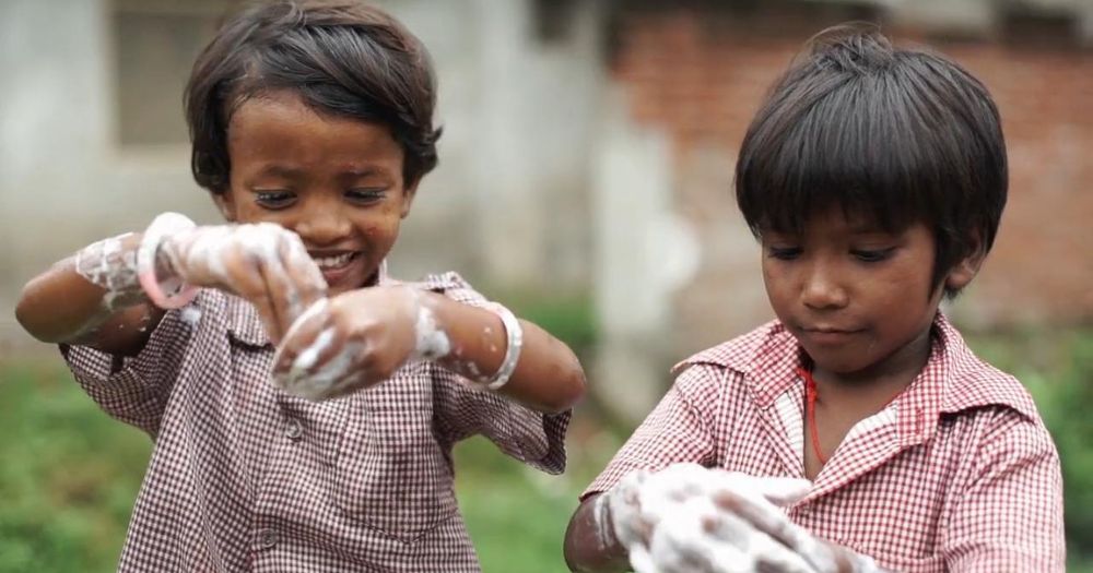 Children washing their hands with soap from Soap Aid