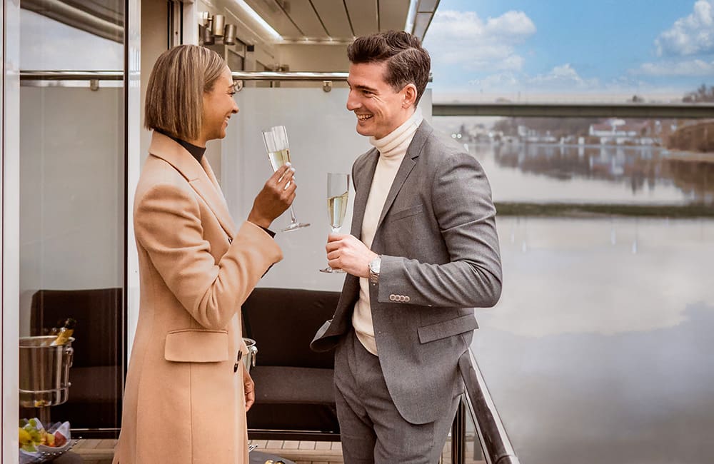 Couple on Stateroom Balcony aboard AmaMagna river ship in Europe.