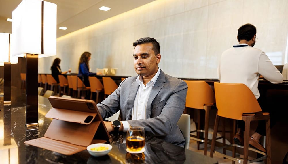 Man working at SilverKris Lounge at London Heathrow Business Class Lounge .