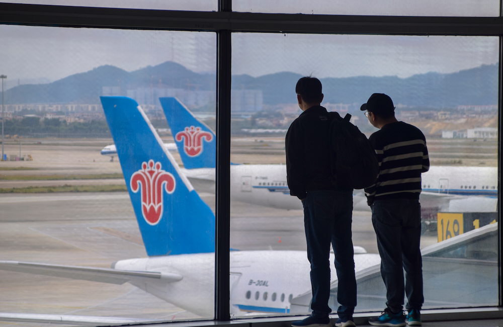 Travellers at Guangzhou Airport.