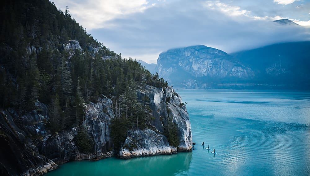 Standup paddleboarding with Norm Hann Expeditions in Squamish, BC. Image: Destination BC/Hubert Kang