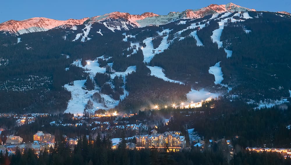 Whistler Village at night with Whistler Mountain in backfround and lights. Image: Destination BC/Randy Lincks