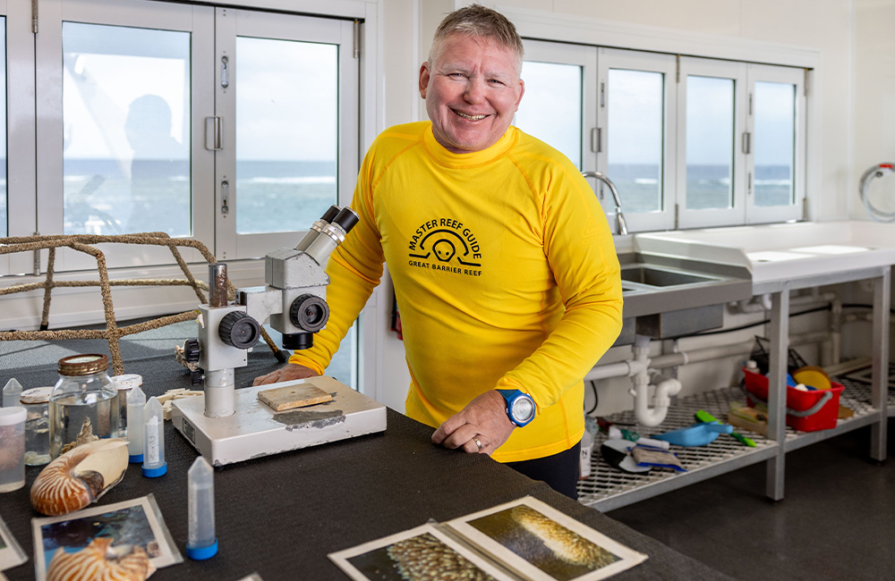 Guardians of the Reef. GBR Biology Manager Eric Fisher in the laboratory on the Reef Magic Pontoon at Moore Reef on the Great Barrier Reef. Image Luke Marsden