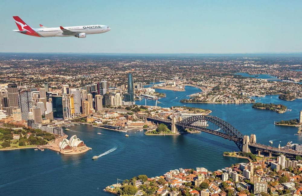 Qantas Airbus A330 aircraft flying over Sydney Harbour.