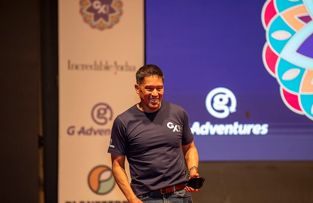 G Adventures Founder Bruce Poon Tip on stage at the GX India 2024 global summit in Jaipur. 2025 GX Jordan