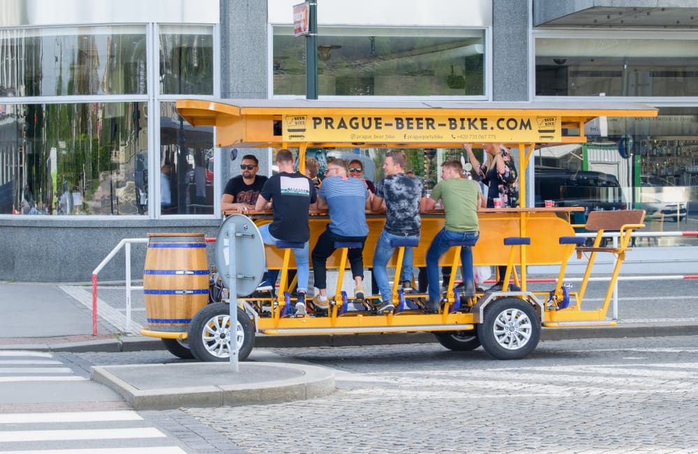 Male tourists on the Prague Beer Bike tour. Image: Tunatura/Shutterstock