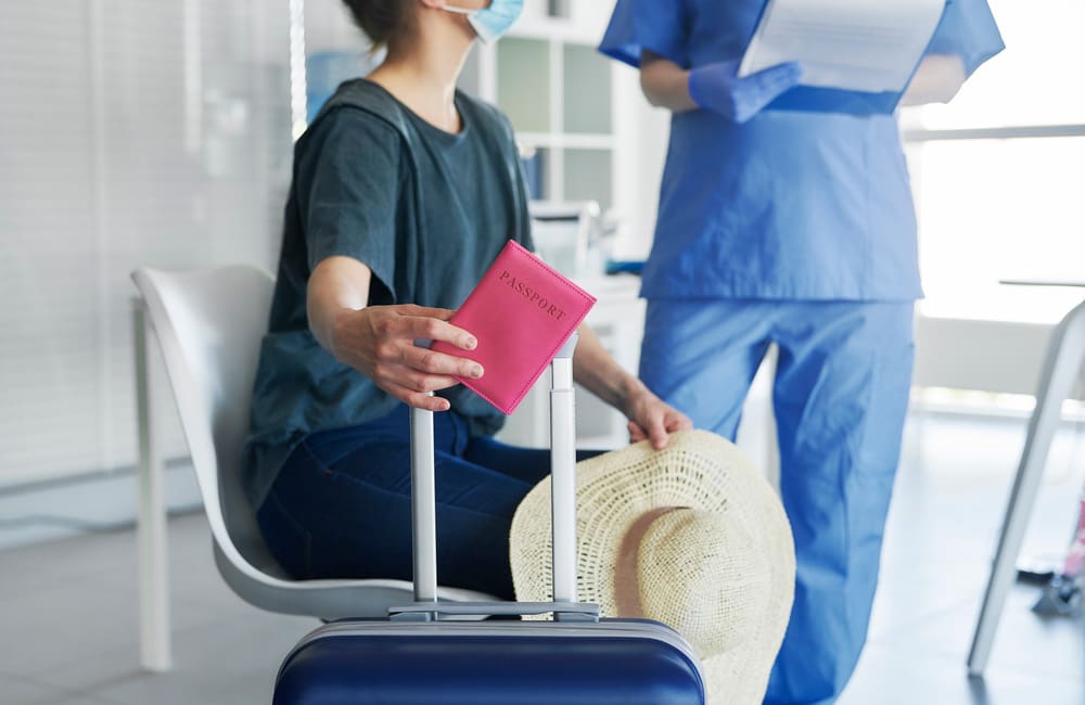 Woman with passport in doctors surgery for medical tourism. Image: Shutterstock