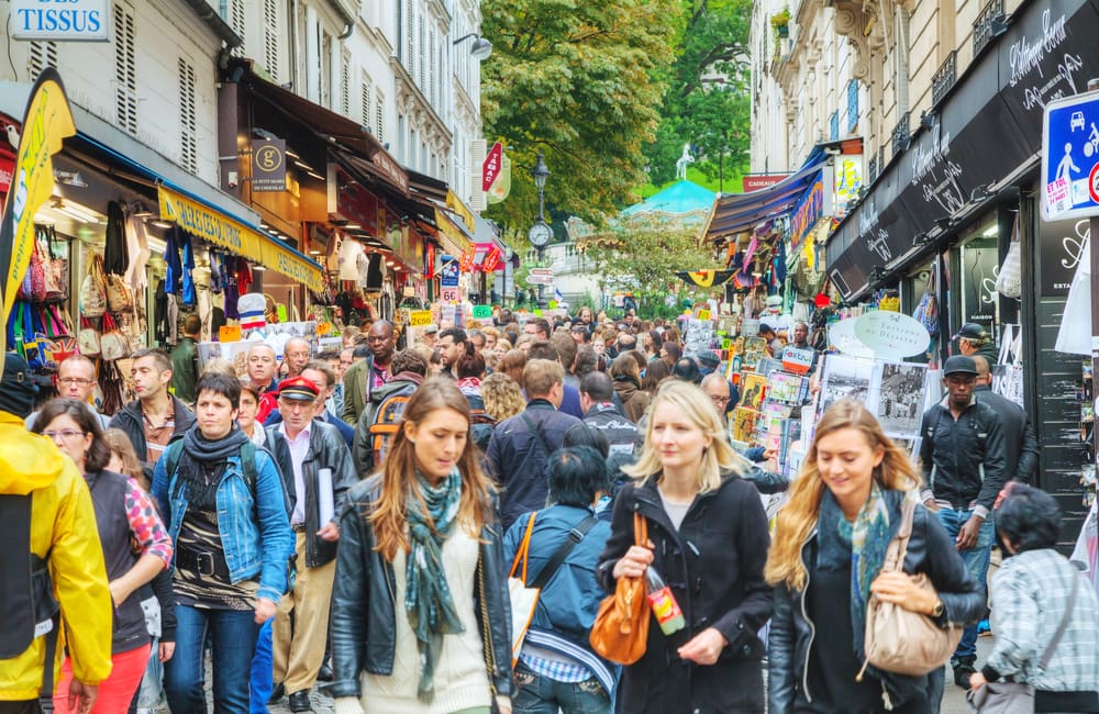 A busy crowded street in bustling Montmartre in Paris. Image: photo.ua/Shutterstock