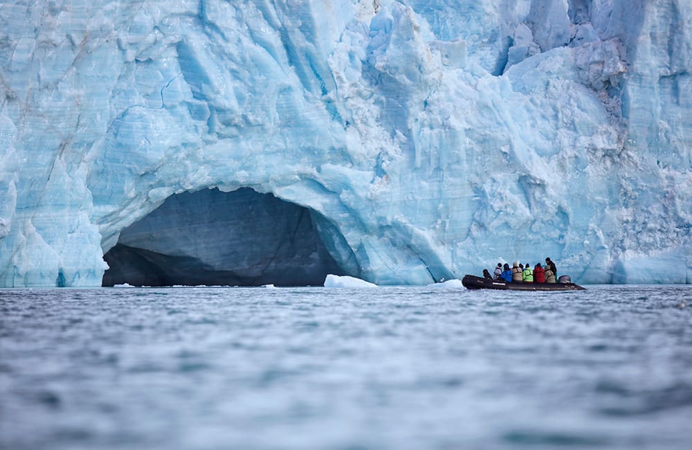 People in Zodiac craft near glacier in Nunavut, Canada. Image: Jason van Bruggen