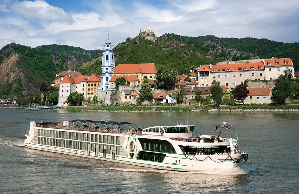 Tauck river cruise ship on Danube River passing Durnstein in Germany.