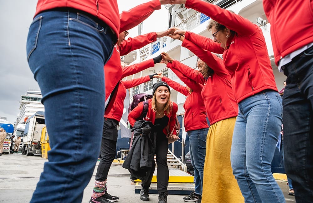 Women form a welcome arch for a fellow cruiser.