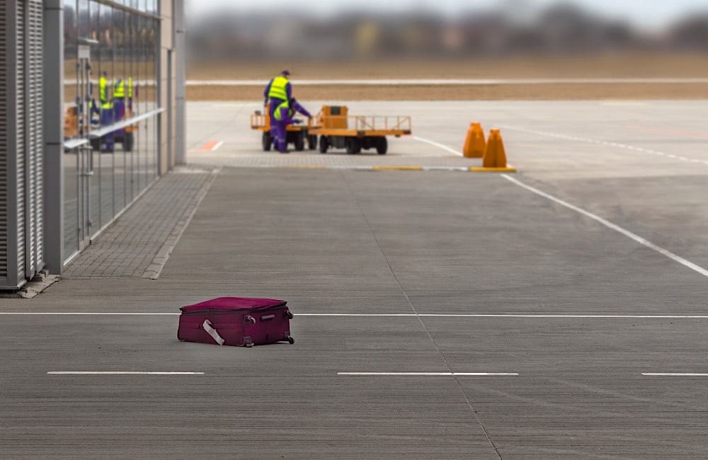 A lone suitcase abandoned on the tarmac—one of the many ways luggage can go missing before it even reaches baggage claim.
