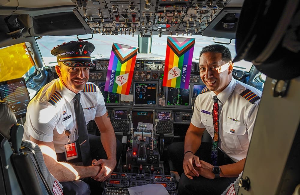 Virgin Australia pilots in uniform and cockpit decorated for Pride Flights.