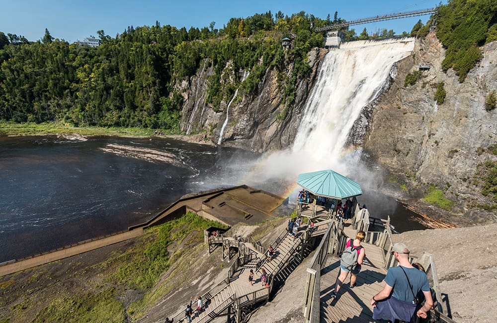 People walking down to the base of the falls at Montmorency Falls Park, Quebec.