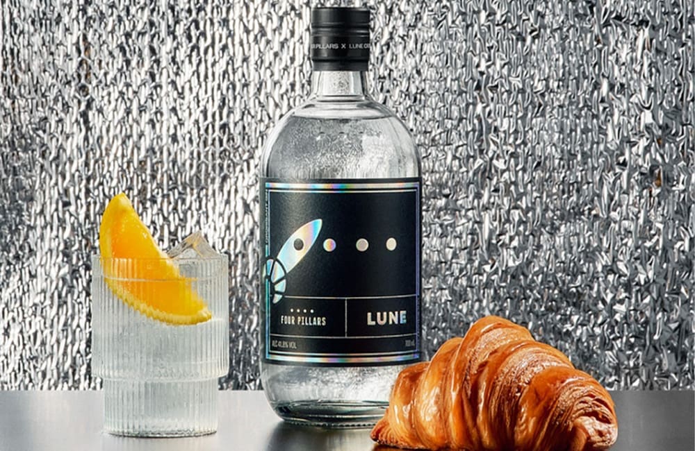 Lune x Four Pillars Gin bottle with croissant and gin and tonic glass.