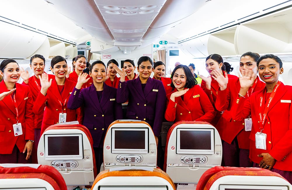 All-female Air India crew in cabin on aircraft.