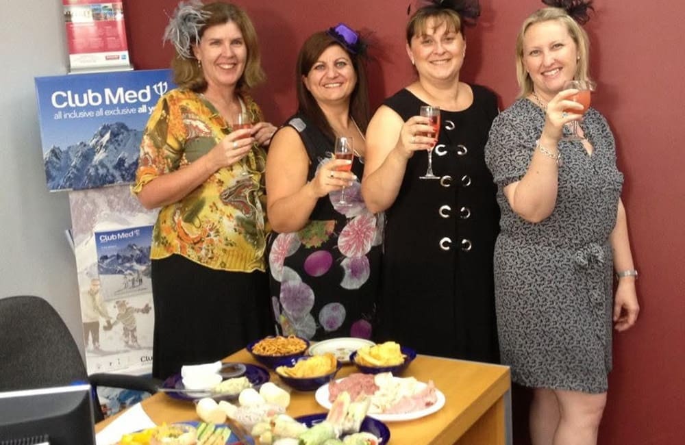 Travel agents dressed up for an office Melbourne Cup party.