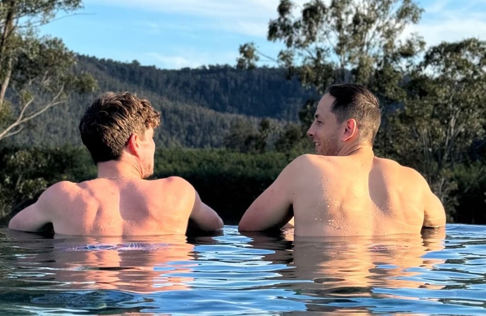 Male couple in pool in rural AU country – LGBTQIA+ tourism accreditation