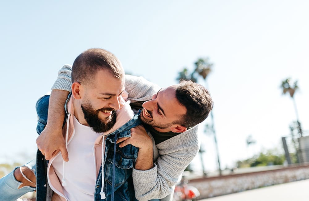 Male couple at beach – LGBTQIA+ tourism accreditation
