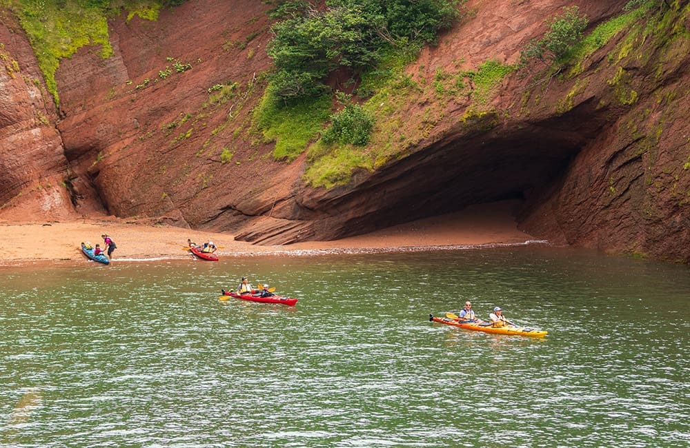 Kayakers in the sea caves at the Bay of Fundy in New Brunswick. Image: Destination Canada