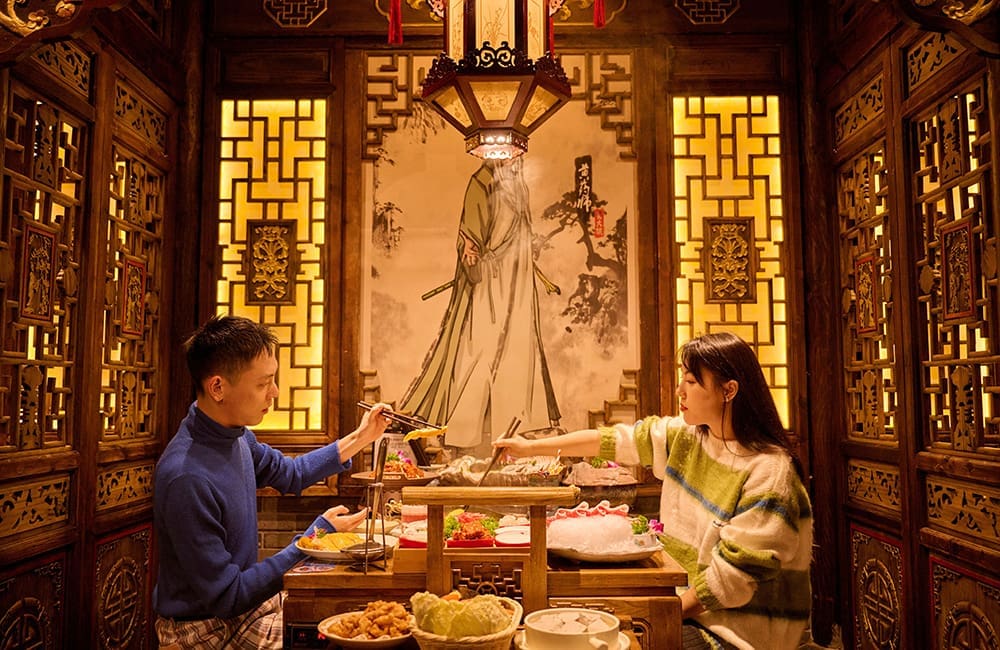 Couple dining in ornate room at Melbourne's Panda Hot Pot restaurant – global foodie city. Image: Visit Victoria
