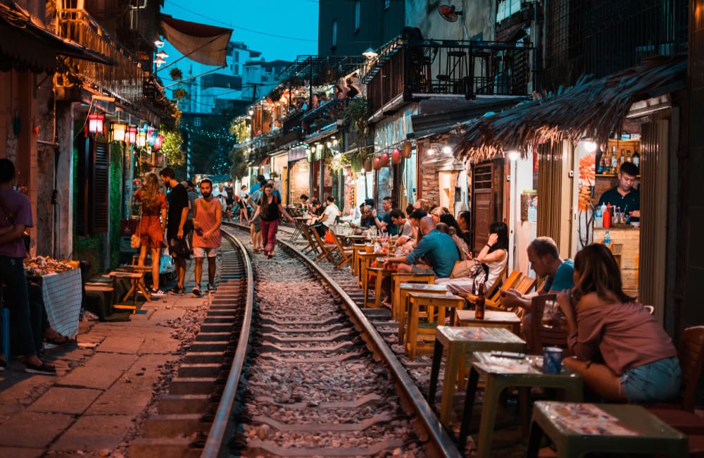 People dining at night at rail street in Hanoi, Vietnam.