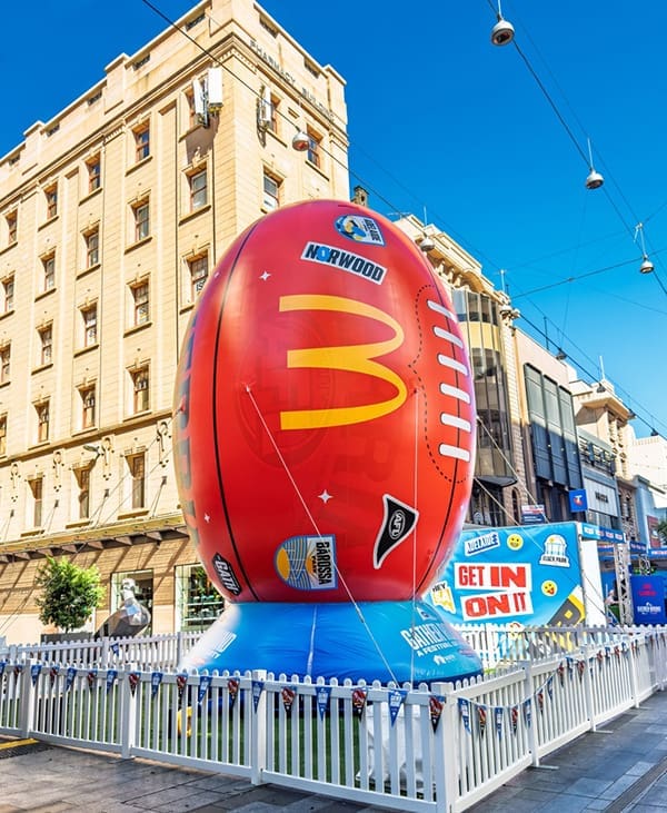 Inflatable football in Adelaide's Rundle Mall to promote the AFL Gather Round in April 2025. Image: Adam Calaitzis/Shutterstock