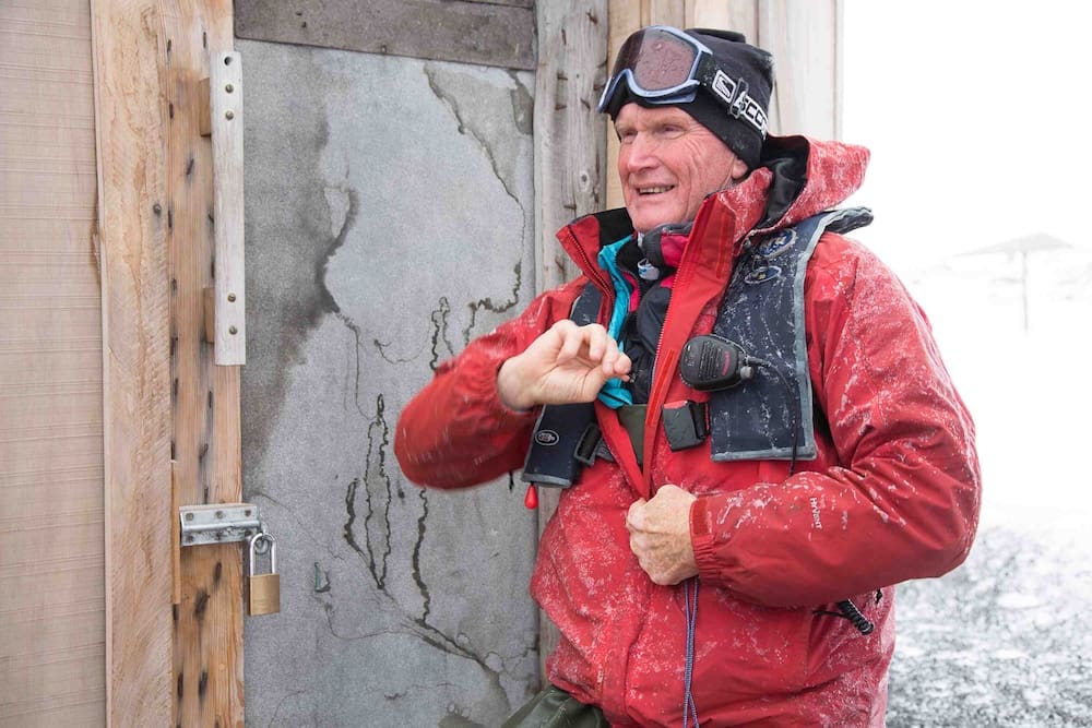 Greg Mortimer opening Scott's hut of the Terra Nova Expedition at Cape Evans on Ross Island, McMurdo Sound, Antarctica.