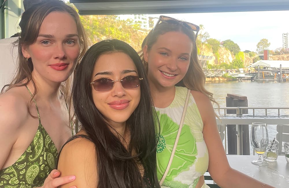 Three Gen Z women outdoors at Howard Smith Wharves restaurant in Brisbane. Karryon Top 10 Stories of the week
