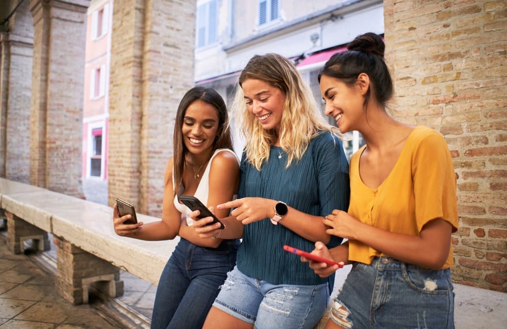 Group of Gen Z women with smartphones.