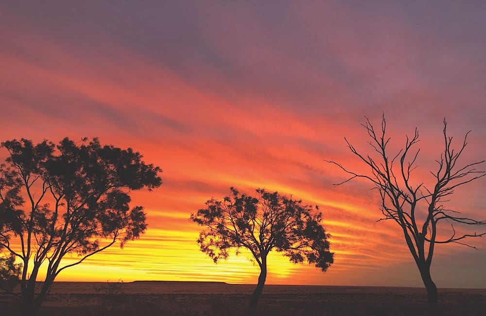 Sunset over the Outback: Campaign packages like the Glamping Getaway include immersive evenings by the firepit under skies like this.