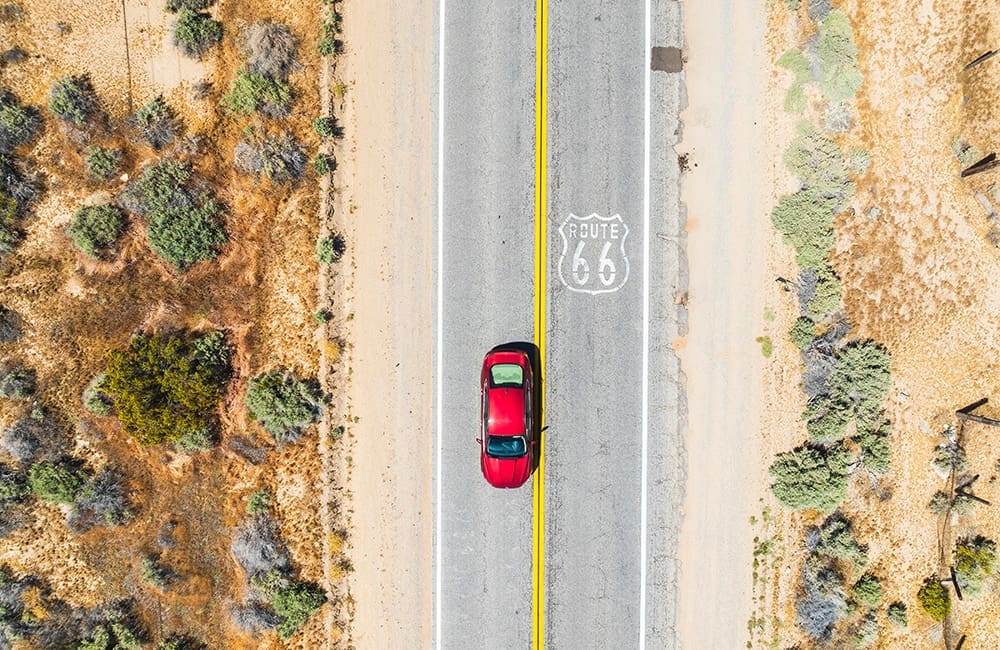 Aerial view of red sedan car on Route 66 in California. Image: David Collier