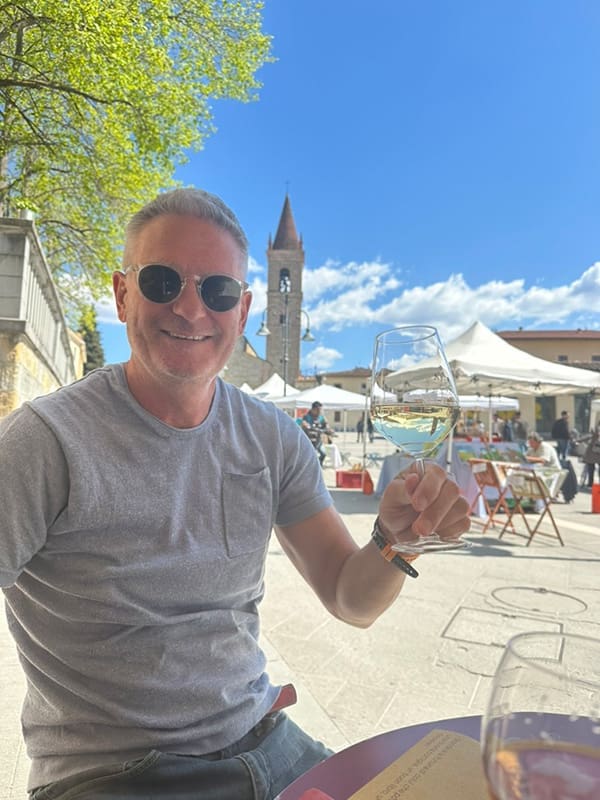 Darren Wright raises a glass at alfresco restaurant in Arezzo in Eastern Tuscany. US luxury travel trends Image: Supplied