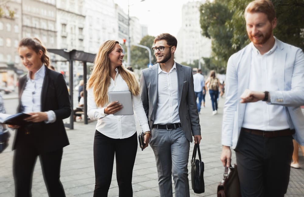 Group of young business travellers walking in a city. Image: Shutterstock