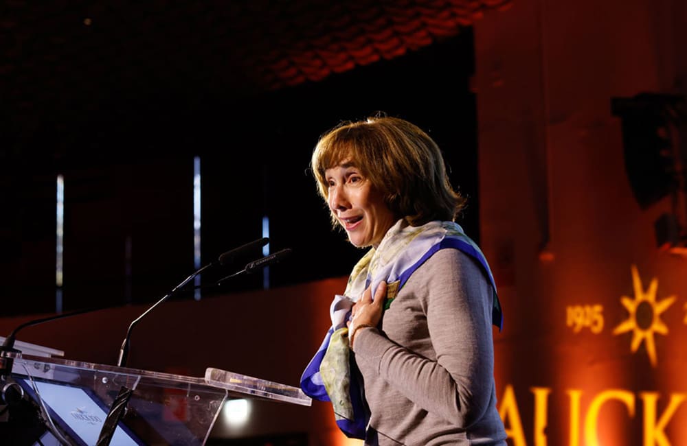 Tauck CEO Jennifer Tombaugh on stage for Tauck 100th celebrations in Florence, Italy