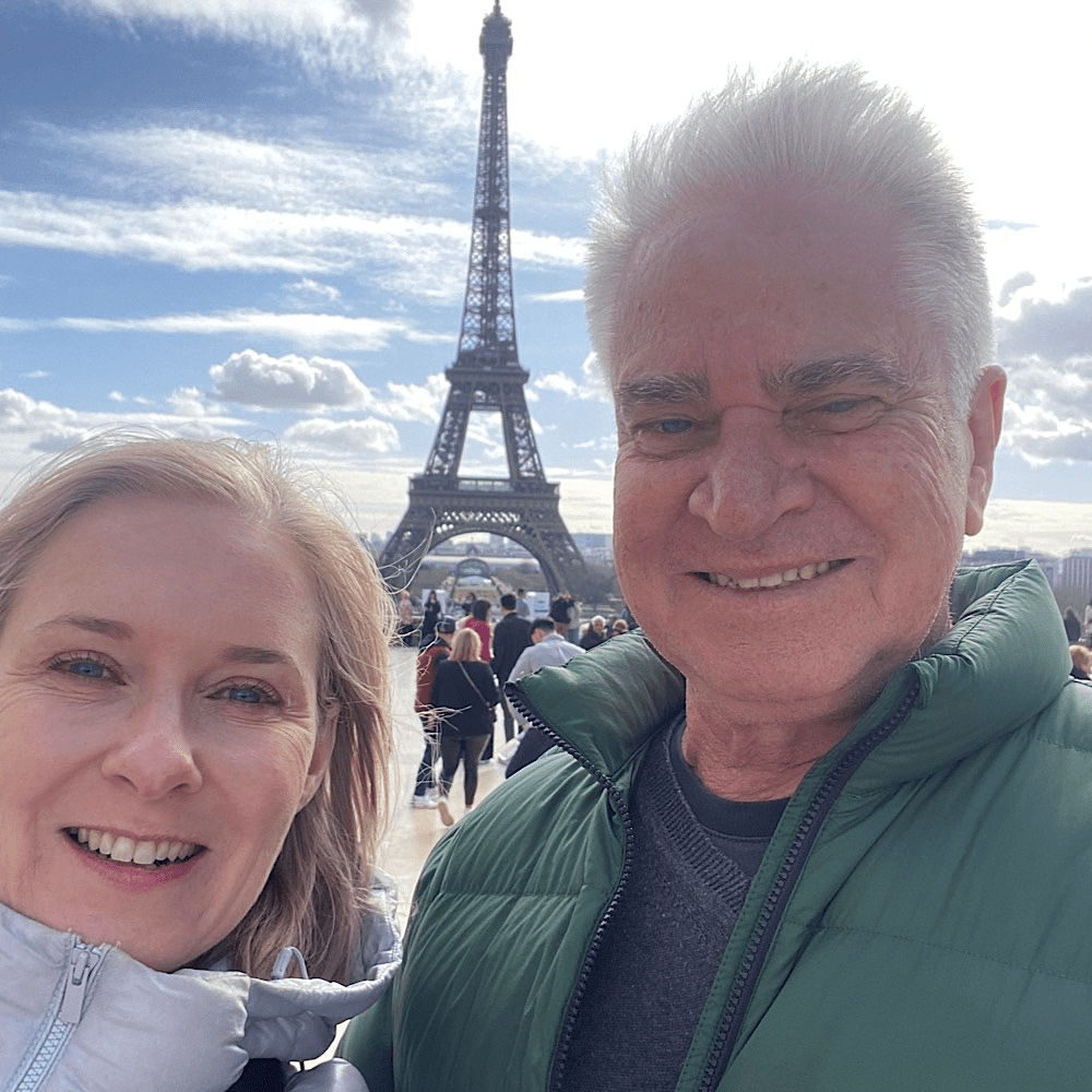 Liz Glover with her husband, an actor and writer, enjoying time in Paris. Her career has taken her from arts and media to global travel brands — but moments like these keep her grounded.