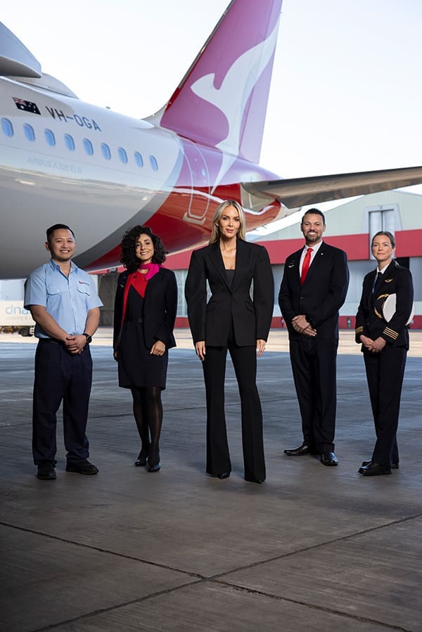 Rebecca Vallance (middle) with QF crew in the current uniform.