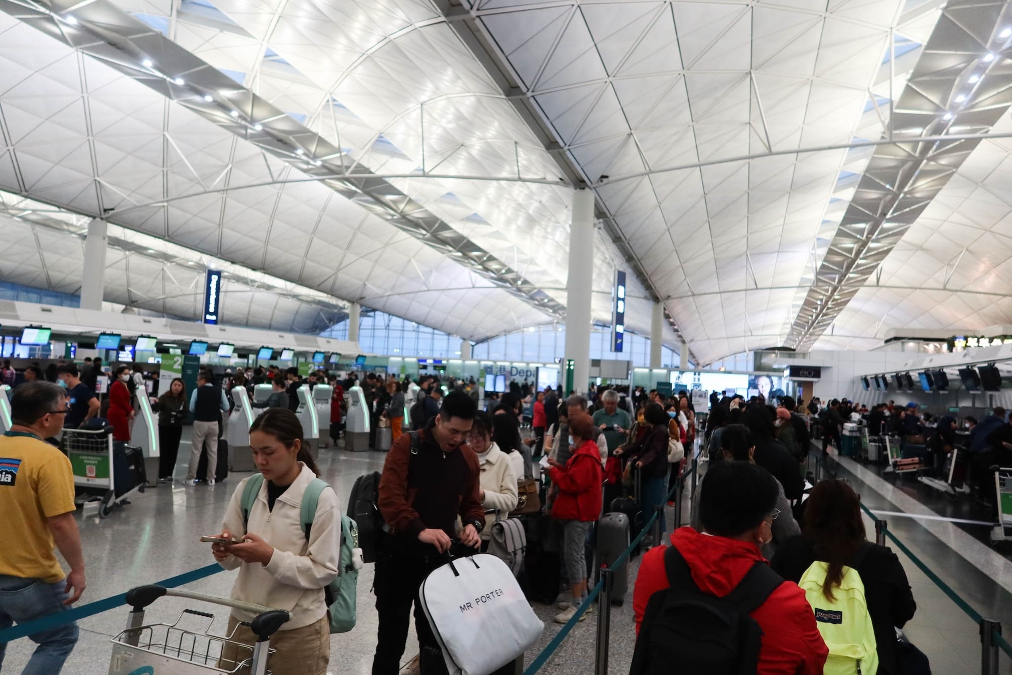 Hong Kong International Airport- 15 March 2024: tourists queuing for check in luggage in airport counter