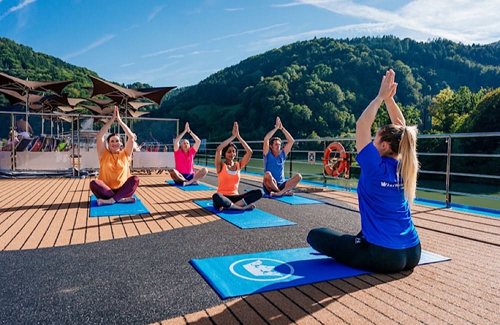 Guests take part in an onboard wellness session during an AmaWaterways river cruise, one of the brand’s signature experiences.