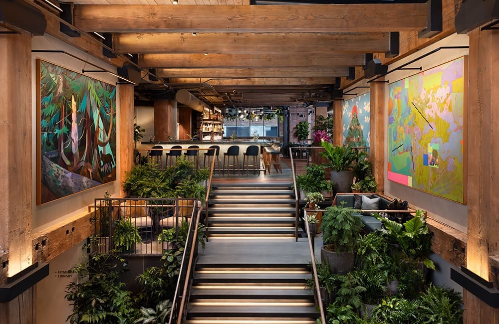 Artwork and greenery adorn the entry stairs at Populus Seattle. Image: Ric Stovall