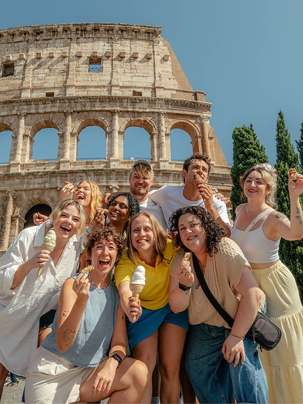 Group of young travellers in front of the Colisseum in Rome. Image: Topdeck