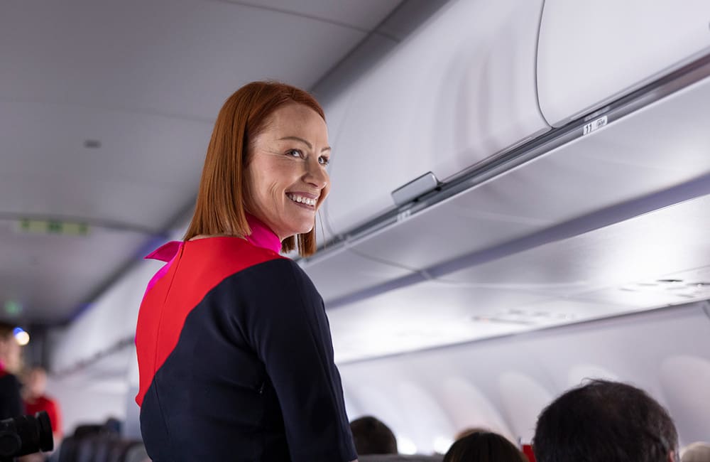 Crew member on Qantas Airbus A321-XLR aircraft – Get on board the Qantas International Red Tail Sale.