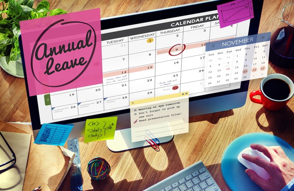 Calendar month on desktop computer with sticky notes about annual leave – maximise your annual leave concept
