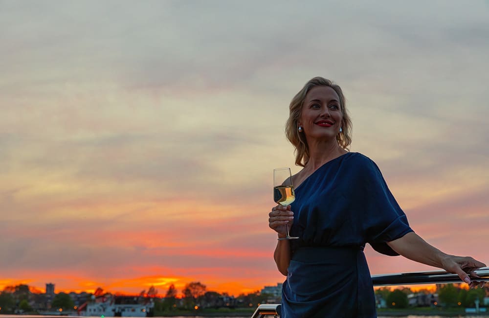 Woman with glass on APT cruise.